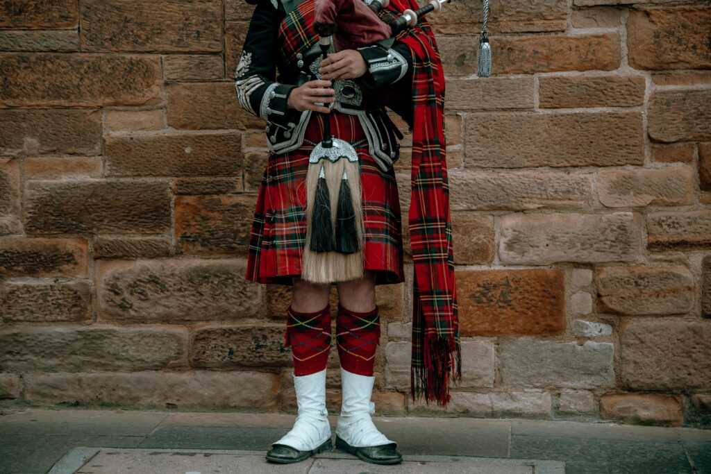 Person wearing a traditional Scottish kilt during Hogmanay celebrations.