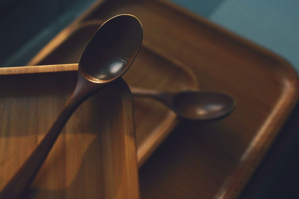Artistic close-up of wooden spoons on wooden trays