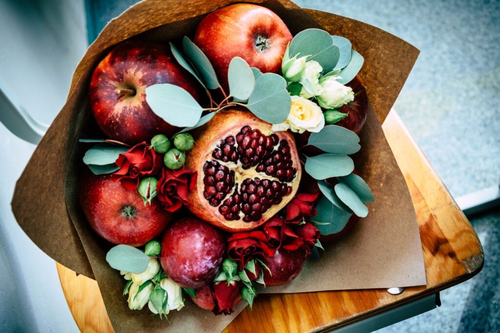 10 Thoughtful Rosh Hashanah Gift Ideas for a Sweet New Year 3 Rosh Hashanah gift ideas with apples, flowers and pomegranate